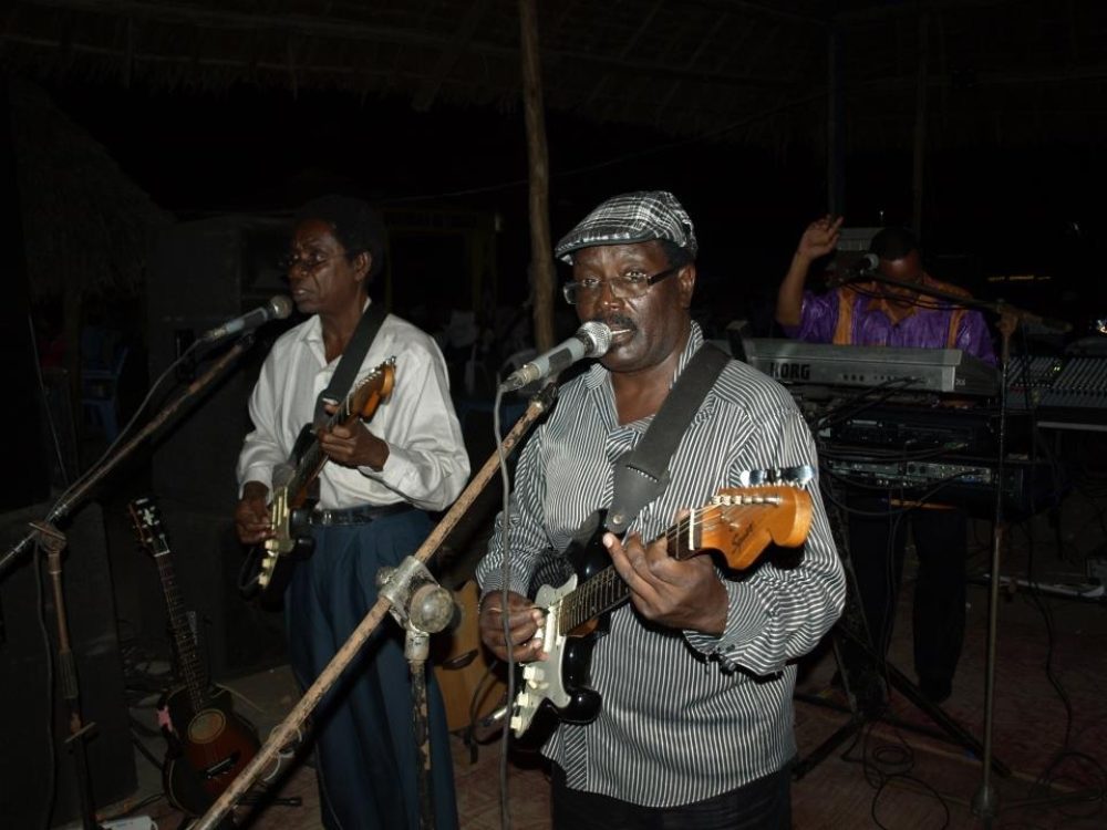 PHOTO: John Kitime, the 60s icon in glasses, playing guitar