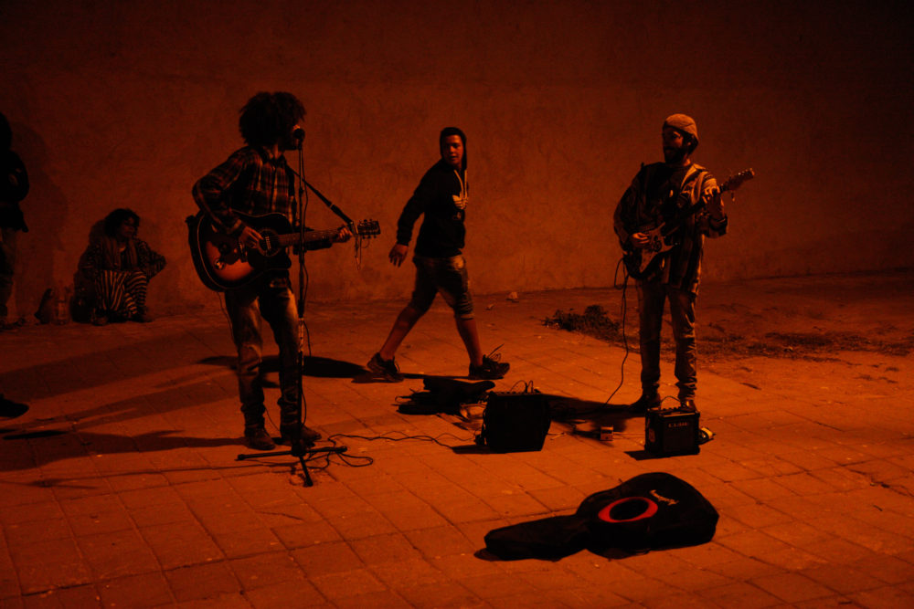 Young musicians busking in the street outside the Moulay Hassan stage.