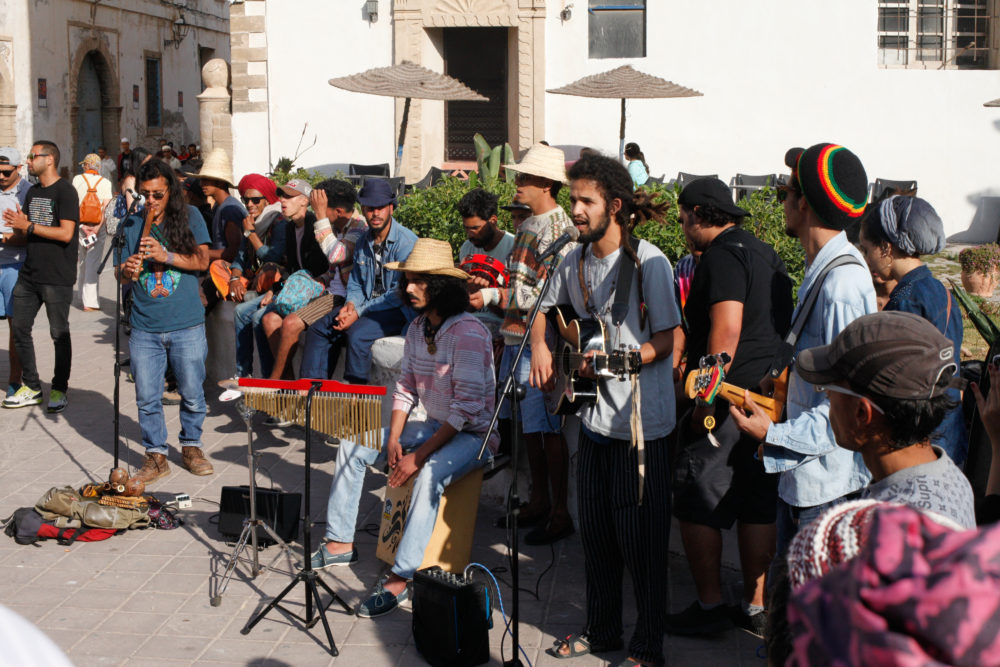 A young band busks on the main avenue in Essaouira, playing rock and reggae
