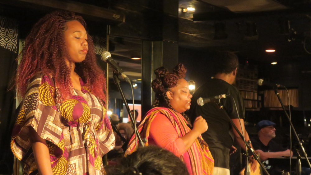 Marie-Claude (center) sings with her husband Fabrice (right) and cousin (left).