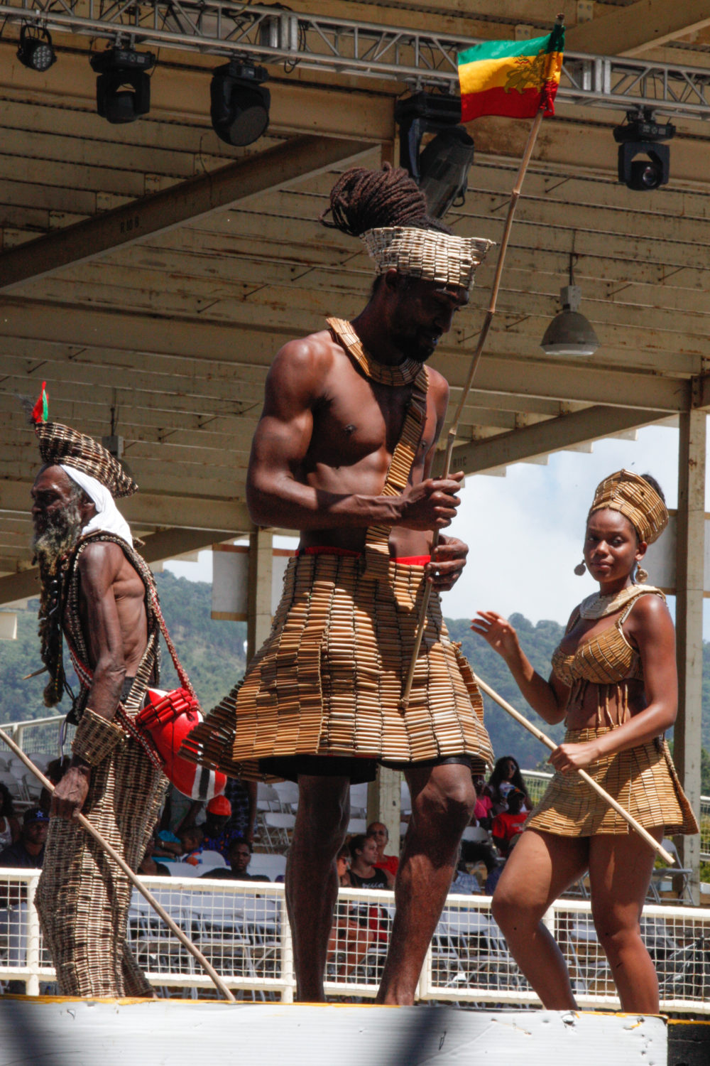 A small band wearing costumes made of grasses and sticks