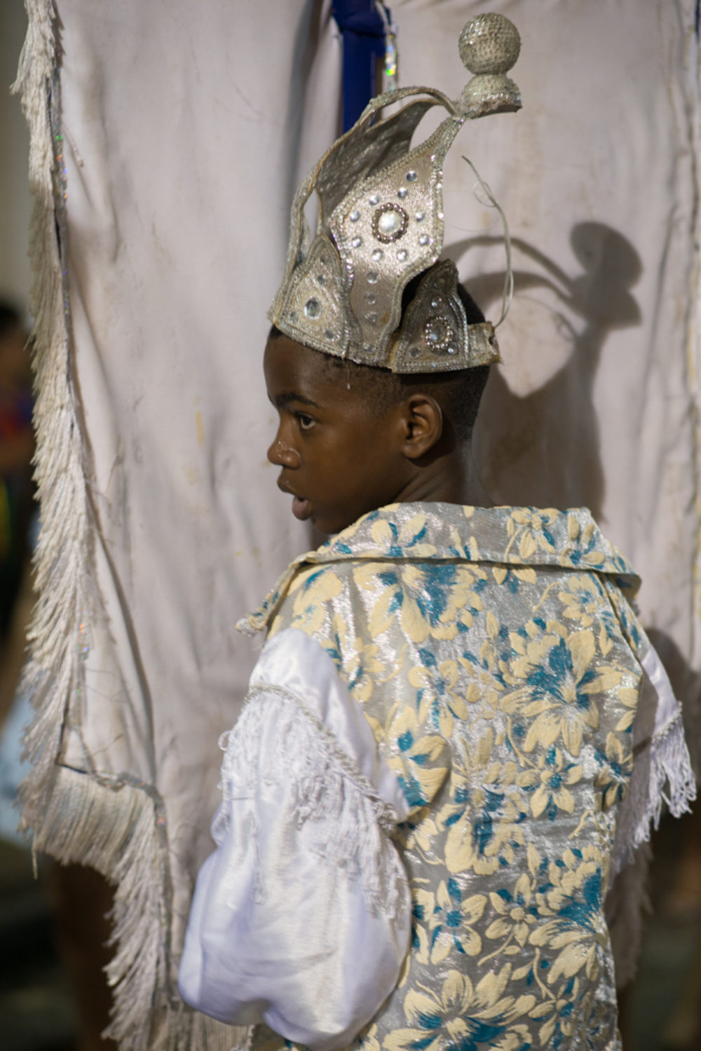Young boy holds the banner of his maracatu troupe