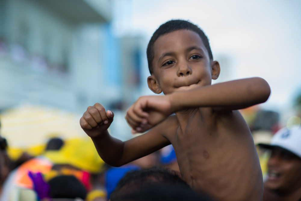 Young reveler on his dad's shoulders