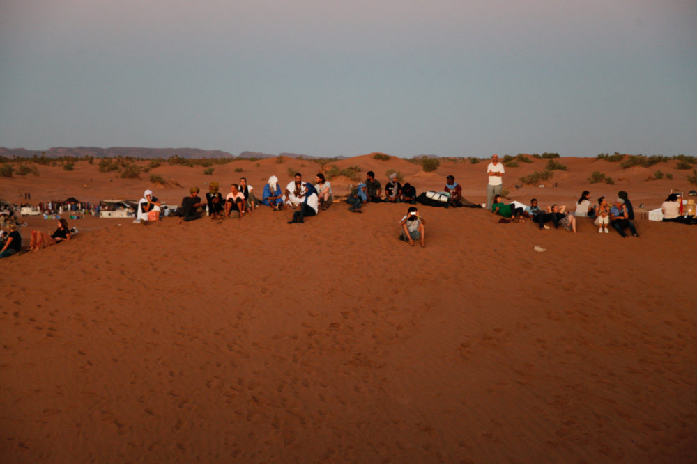 The festival crowd gathers for the sunset.