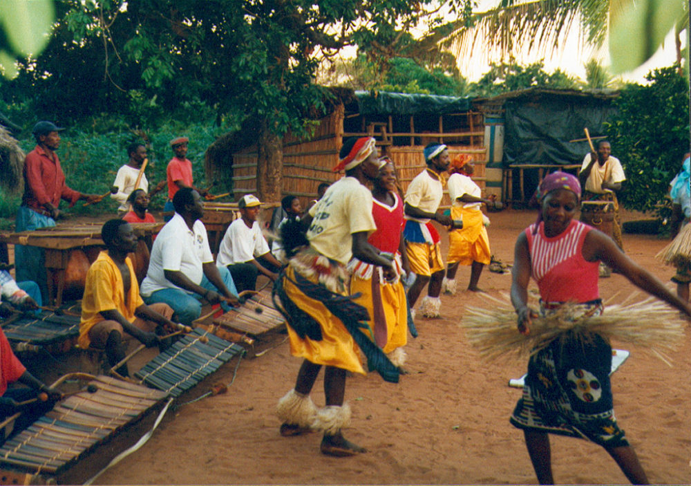 Venancio Mbande (in white, center) and his group performing in Zavala (Eyre, 1998)