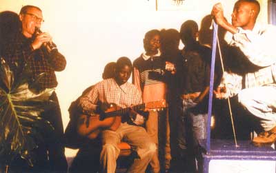 Gerhard Kubik playing with musicians from Malawi