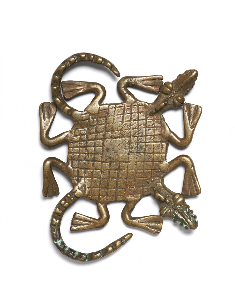 A gold-weight in the shape of a two-headed crocodile made in Ghana and used for weighing gold dust, made c 18th – 20th century and on display in West Africa: Word, Symbol, Song. The crocodile symbolizes cooperation and interdependence. 