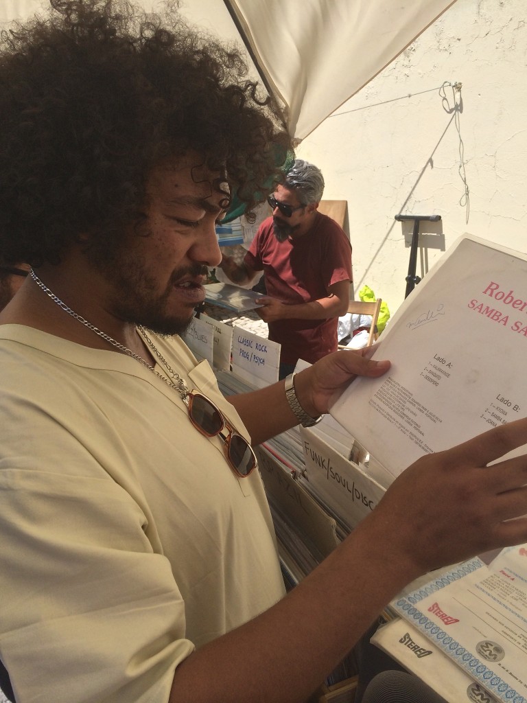 Wilson Vilares from Celeste/Mariposa sorts through records at the Feira de Ladra.