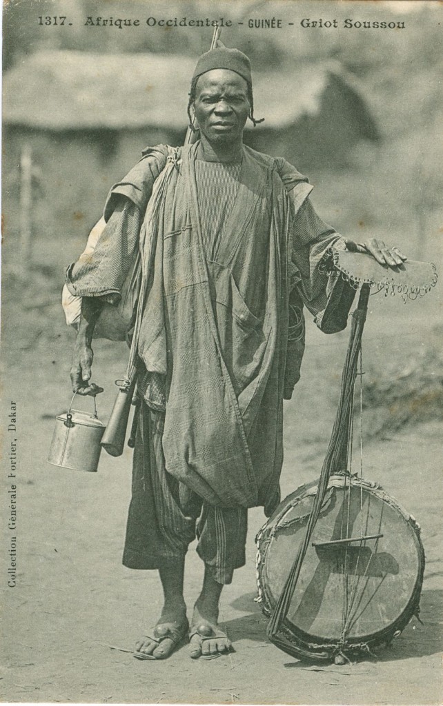 This image shows a griot (musician and storyteller) with his kora (calabash harp). It is the work of Edmond Fortier, a French photographer who spent nearly 30 years working in West Africa, mainly Senegal, in the early 20th century. 