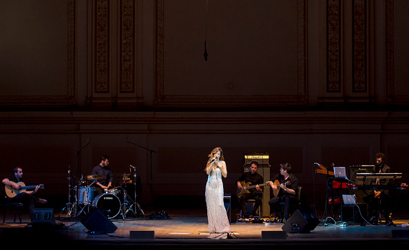 Portuguese fado singer Ana Moura (born Ana Claudia Moura Pereira) performs with her band at Carnegie Hall, New York, New York, April 26, 2016. With her are, from left, Pedro Soares, on acoustic guitar, Mario Costa, on drums, Andre Moreira, on electric bass guitar, Angelo Freire, on Portuguese guitar, and Joao Gomes, on keyboards. (Photo by Jack Vartoogian/Getty Images)