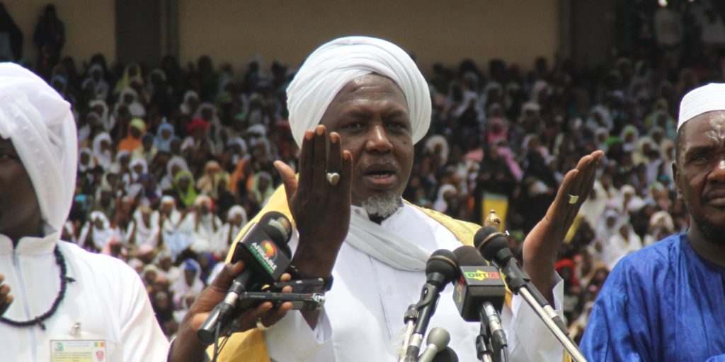 Mahmoud Dicko (C), head of Mali's High Islamic Council prays on August 12, 2012 in Bamako during a giant peace rally in Mali. Up to 60,000 people gathered Sunday for a giant peace rally in Mali, a country split in two after Islamists wrested control of northern desert regions after a March coup in the capital Bamako. The meeting for "national peace and reconciliation" in Bamako's main stadium was called by the country's top Muslim body and drew several key politicians including Prime Minister Cheikh Modibo Diarra. AFP PHOTO / HABIBOU KOUYATE (Photo credit should read HABIBOU KOUYATE/AFP/GettyImages)